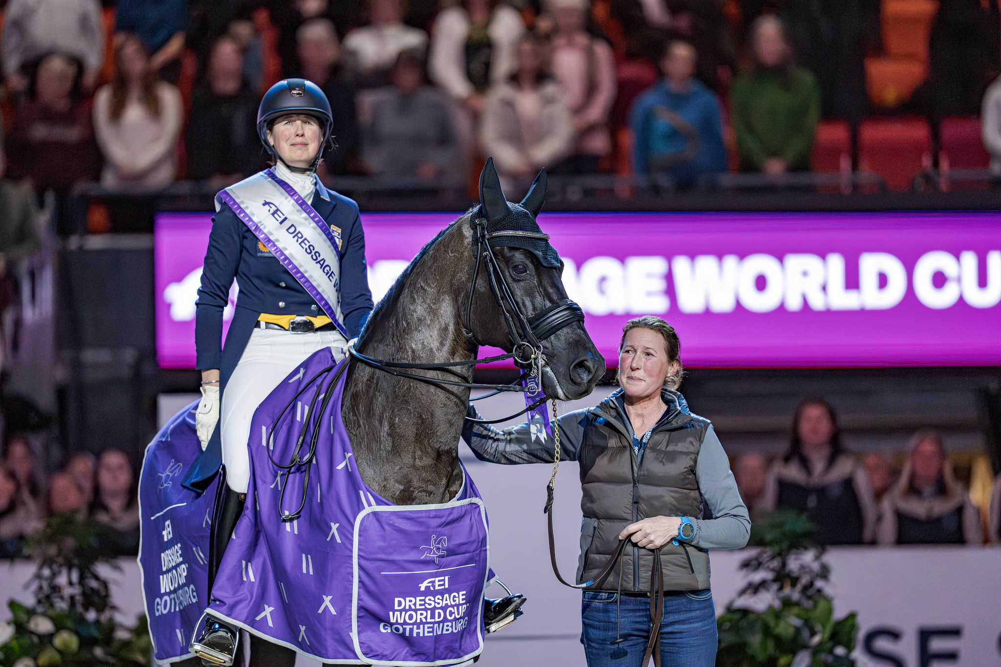 Pure emotion: Maria von Essen (SWE), Invoice and cousin Ebba listen to the national anthem after winning the Gothenburg Horseshow. Photo: FEI/Kim C. Lundin 